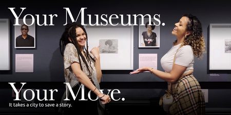 Two smiling people in a gallery with the text that reads 'Your Museums. Your Move.'