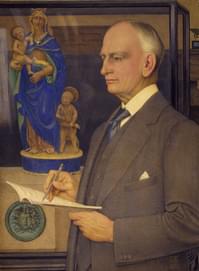 A profile portrait of a man in a suit, he holds a pen and paper. A sculpture of a lady and two children is in a display case behind him.