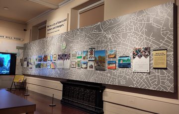 A display of community art, local Birmingham streets and houses. Photo includes further information of Arts Therapies UK.