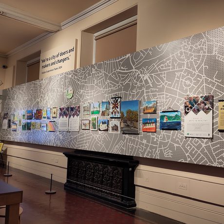 A display of community art, local Birmingham streets and houses. Photo includes further information of Arts Therapies UK.