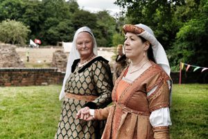 Two ladies dressed in medieval replica costumes.