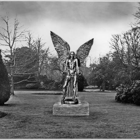 Black and white photograph of a park with grass and trees. An image of the statue of Lucifer has been overlaid over it.