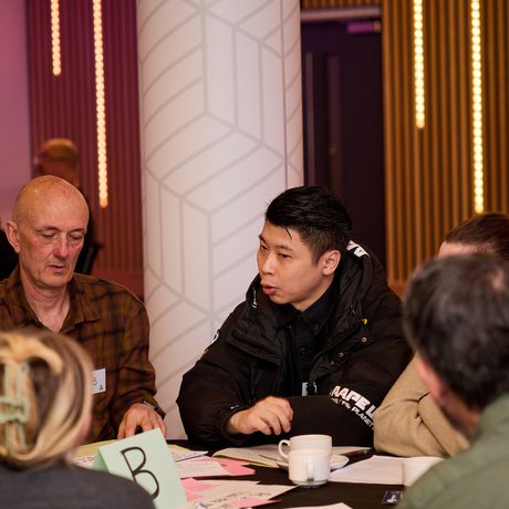 A group of participants sitting around a table having a discussion.