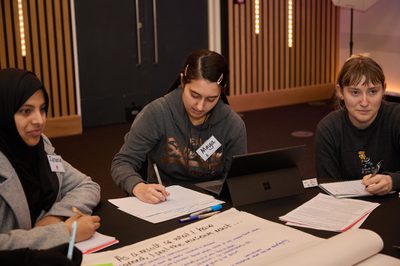 A group of participants sitting around a table having a discussion.