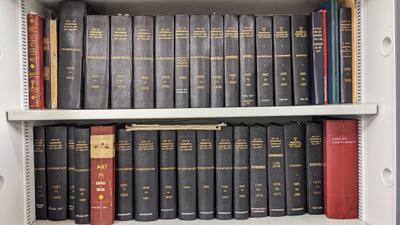 Two rows of books in a cupboard entitled City of Birmingham Museum and Art Gallery'.