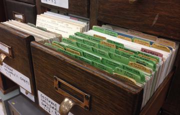 An open drawer showing paper files and documentation.