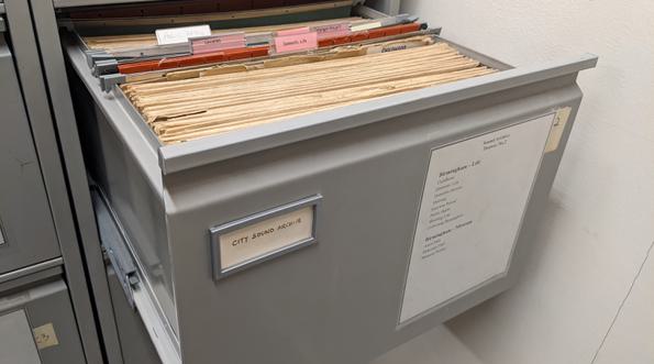 Open filing cabinet drawer with files inside