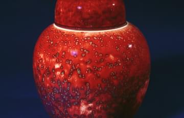 Bright red ceramic vase with lid