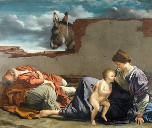 Religious painting of Mary, Joseph, and the infant Jesus resting, the mother feeds the baby, the father sleeps. A donkey looks over a partially fallen wall in the centre.