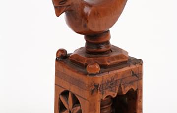 Wooden box with bird shape on the top, a screw inside can be turned to crack nuts