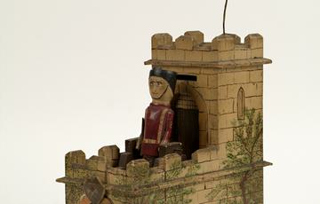 Novelty metal and wood money box shaped like a fort