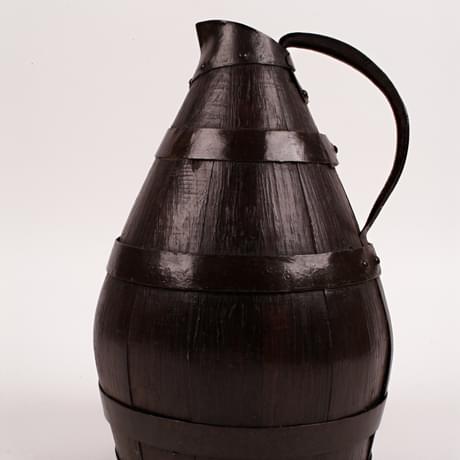 Wooden barrel-shaped jug with a metal handle