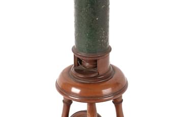 Early microscope, a wooden tube on a stand above a small mirror