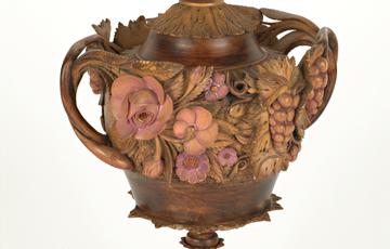 Very ornate wooden carved cup with 3D flowers, the lid has a dragon on the top