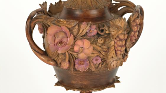 Very ornate wooden carved cup with 3D flowers, the lid has a dragon on the top