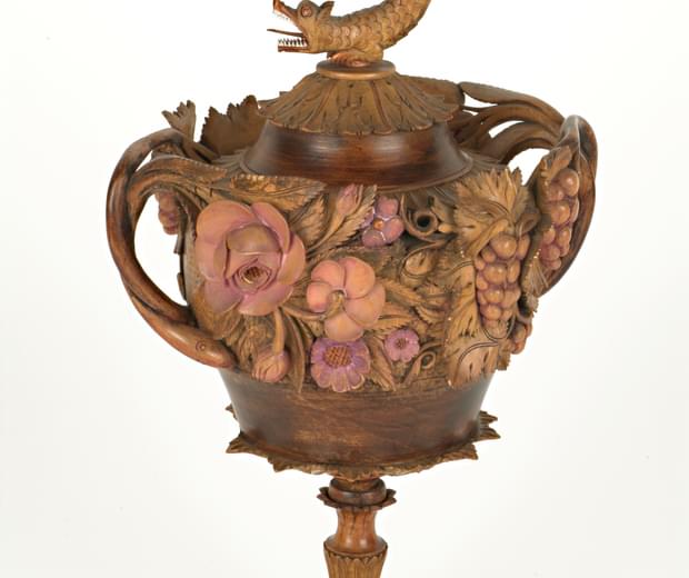 Very ornate wooden carved cup with 3D flowers, the lid has a dragon on the top