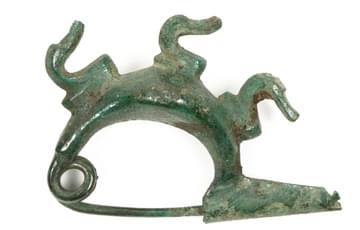 Metal decorative pin in a crescent shape with three sylised duck heads on the top