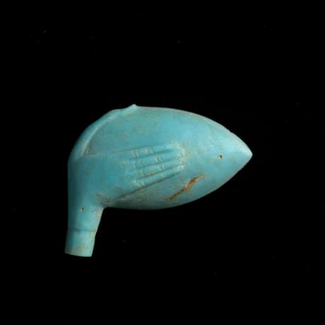 Small blue pottery spoon head, a shape of a hand decorates the back and forms a handle