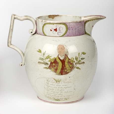 A pottery jug with handle and spout. It is white and decorated with a painted portrait and script
