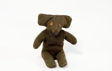 Small cloth toy formed to resenble a bear