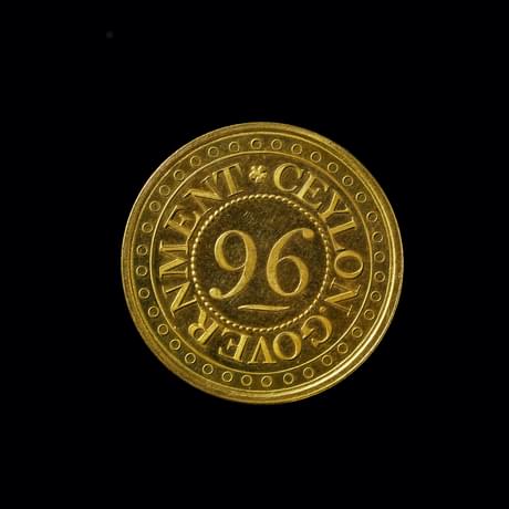 Gold coloured coin with the number '96' in the centre and 'Ceylon Government' round the edge