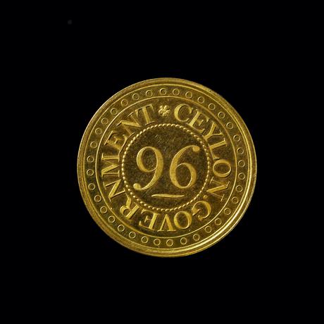 Gold coloured coin with the number '96' in the centre and 'Ceylon Government' round the edge