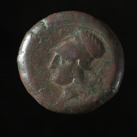 Dark coin, worn smooth, with figure's bust in the centre as they look to the left