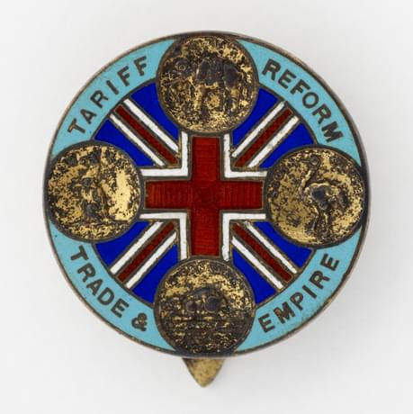 A badge with the Union Jack and 'tariff reform trade & empire' inscribed