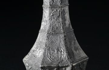 Religious artefact, a patterned bottle made of tin