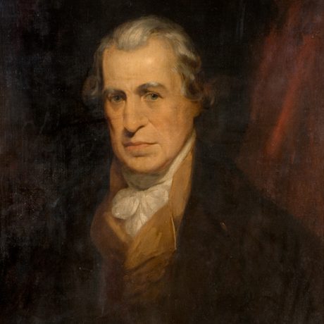 An 18th-century man with white hair wearing a brown coat and white cravat.