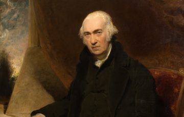 Elderly man in dark clothing seated on ornate chair, contemplative expression, classical portrait style.