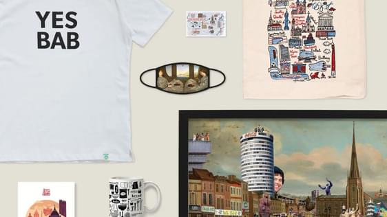 A selection of shop products including: t-shirt, artwork, mug, bag, book, mask, jewellery and mirror.