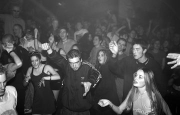 A group of people dancing in a club.