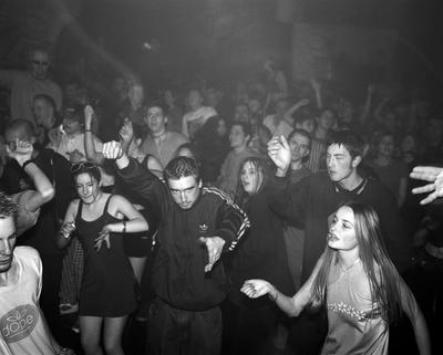 A group of people dancing in a club