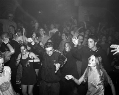 A group of people dancing in a club.