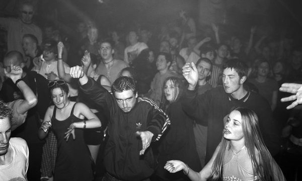 A group of people dancing in a club.