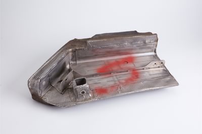 A section of metal with read spray paint on an area.