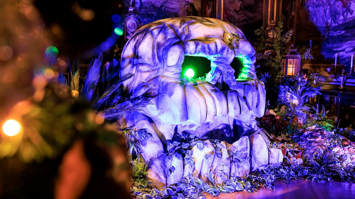Neverland - a indoor Peter Pan experience. Showing a replica skull with glowing green eyes.