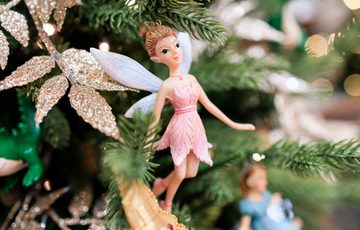 Neverland - a indoor Peter Pan experience. Showing a close up detail of a fairy on a tree.