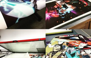 A collage of 4 posters displayed on a table.