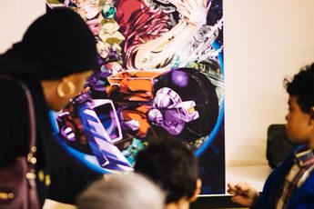 An adult and children looking at a poster in display.