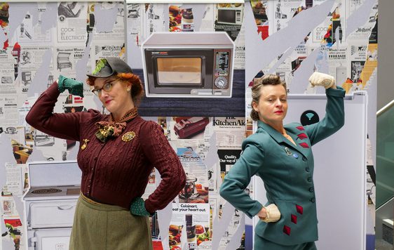 Two ladies dressed in vintage posing.