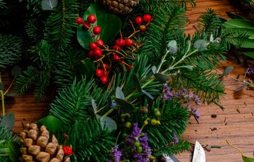 A wreath and tools on a table.