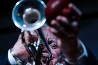 Close up of a person playing a trumpet.