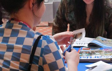 Two ladies sitting at a blue table
