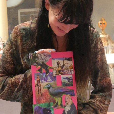 Picture of a lady with dark hair holding a finished collage