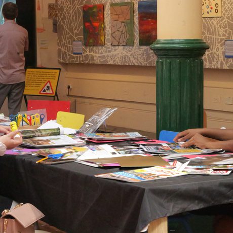 Picture of a table with two people doing craft activities