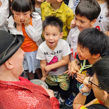 An adult with a group of smiling children.