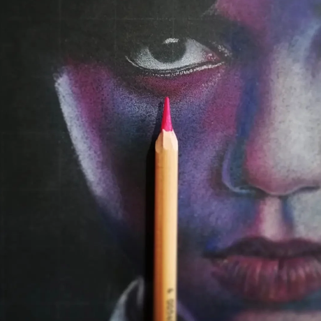 Pencil drawing of a face in shades of reds and purples with a pink pencil on top