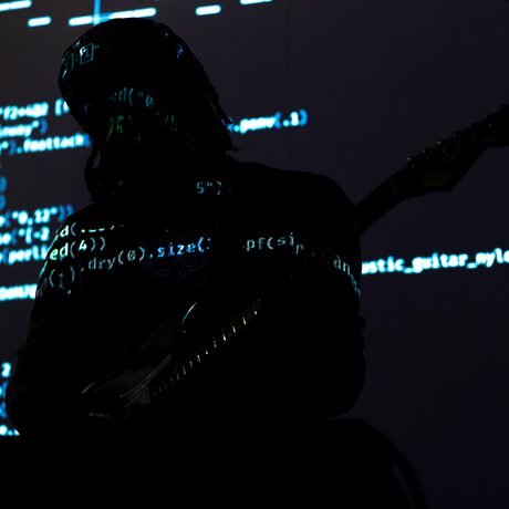 Computer code projected over a silhouette of a person.